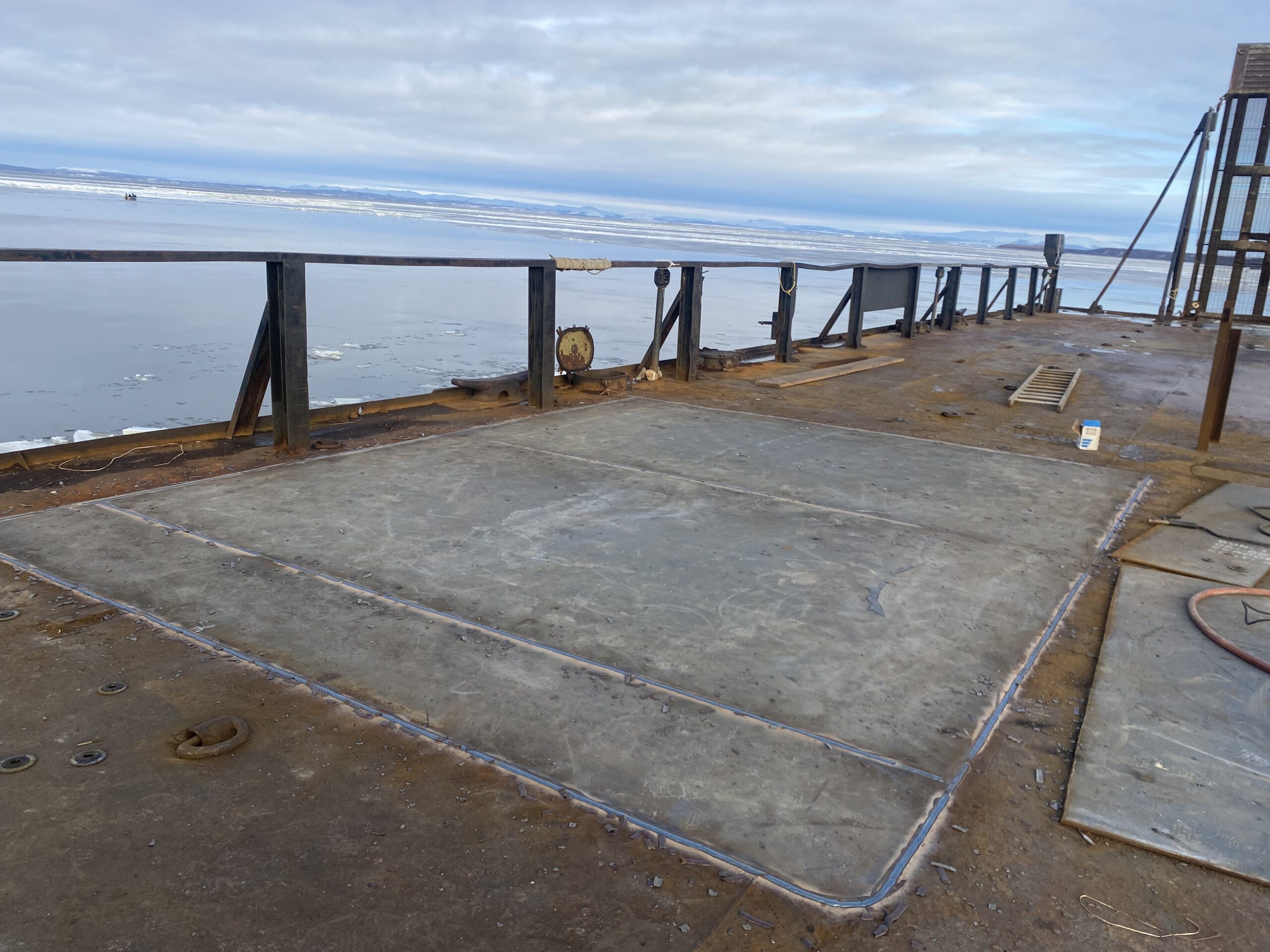 Deck plate renewal on vessel in remote Alaska. Deck plate renewal with remote Alaskan water in the background.
